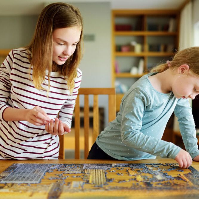 Two Girls Playing With Puzzle uai